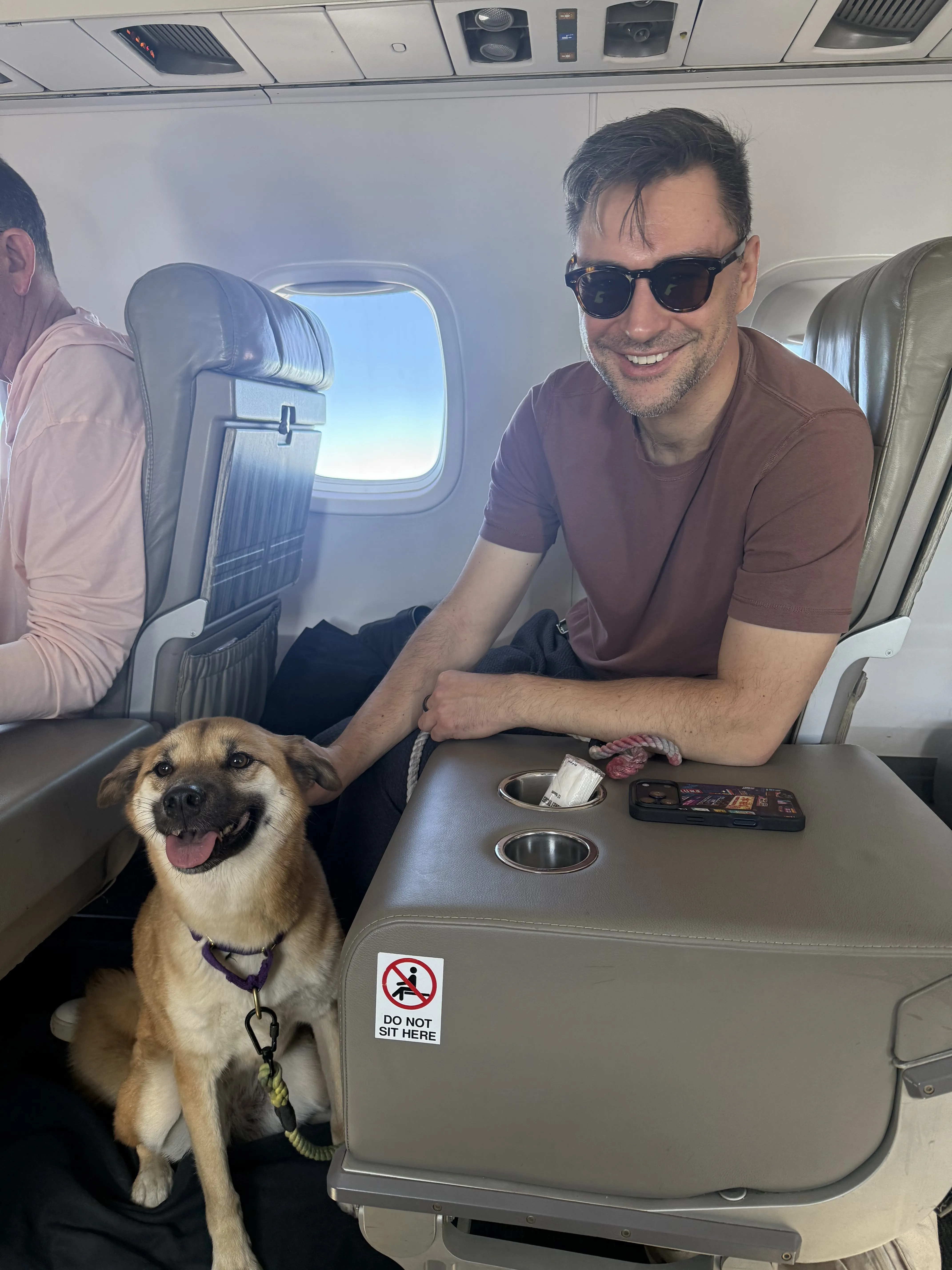 Dan and Nika sitting on a flight to Florida